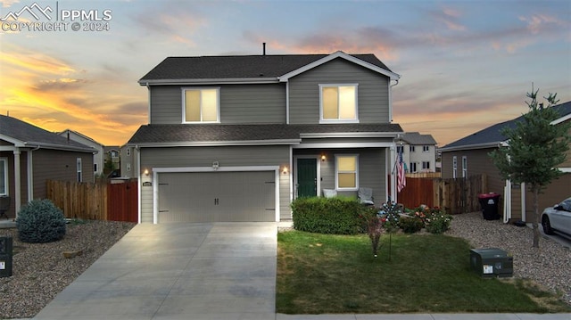 view of front facade featuring a garage and a lawn