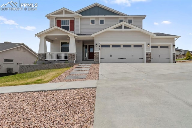 craftsman inspired home with a porch and a garage