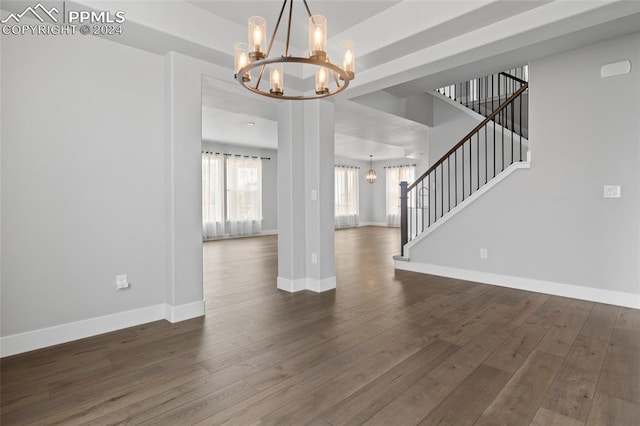 interior space featuring dark hardwood / wood-style floors and an inviting chandelier