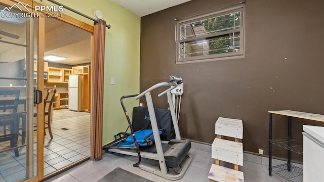 workout area with light tile patterned flooring