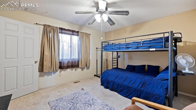 carpeted bedroom with a textured ceiling and ceiling fan