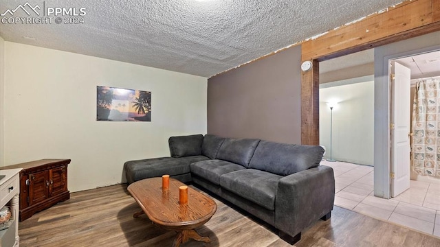 living room with light hardwood / wood-style floors and a textured ceiling