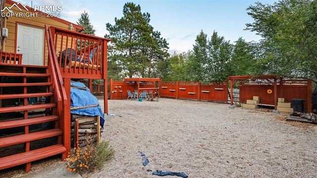 view of play area with an outdoor structure and a deck