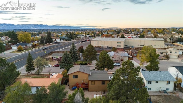 aerial view at dusk featuring a mountain view