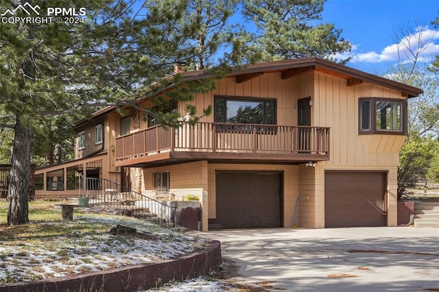 view of front of property featuring a garage and a balcony