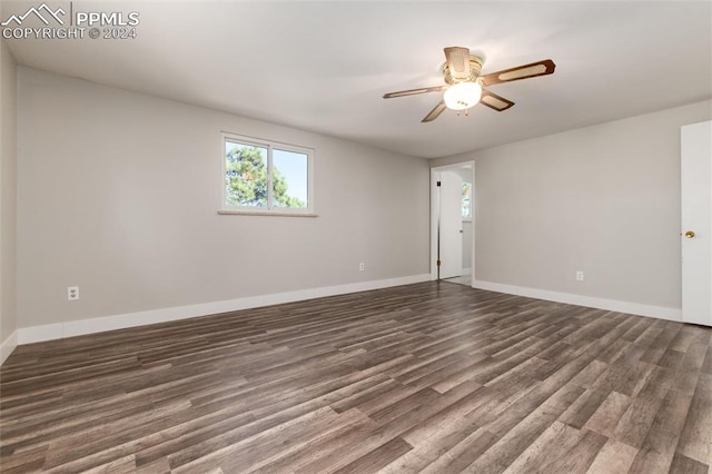 unfurnished room with ceiling fan and dark hardwood / wood-style flooring