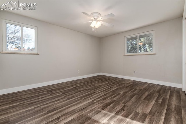 empty room with dark wood-type flooring and ceiling fan