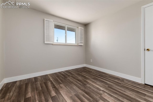 empty room with dark hardwood / wood-style floors