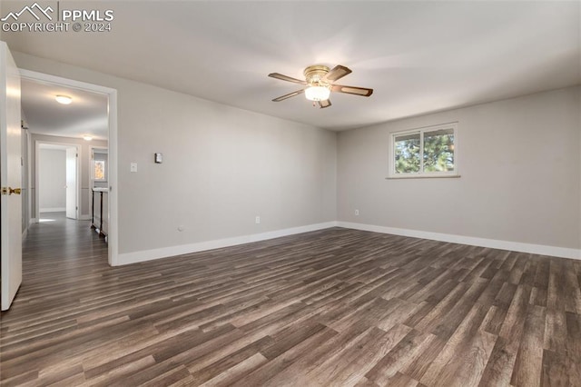 unfurnished room with dark hardwood / wood-style flooring and ceiling fan