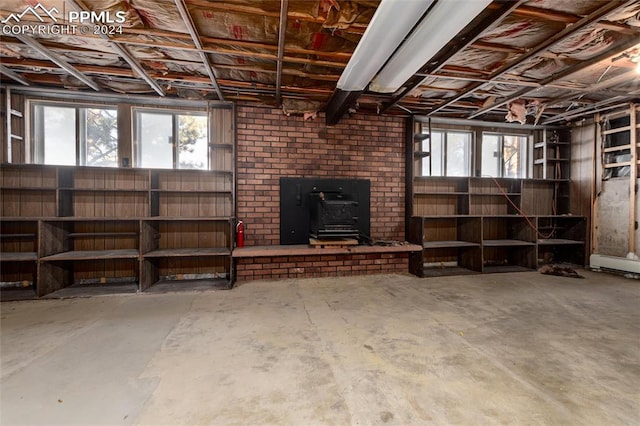 basement featuring a wood stove and a wealth of natural light