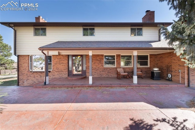 back of property with a porch