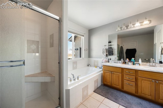 bathroom with tile patterned flooring, vanity, and independent shower and bath