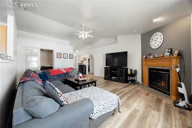 living room with hardwood / wood-style flooring, vaulted ceiling, and ceiling fan