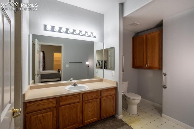 bathroom with toilet and vanity