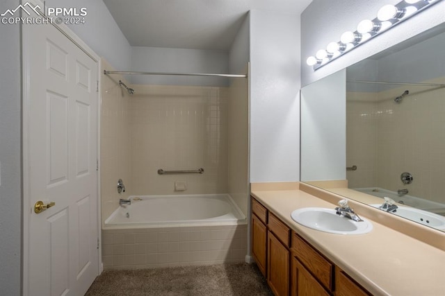 bathroom featuring vanity and tiled shower / bath