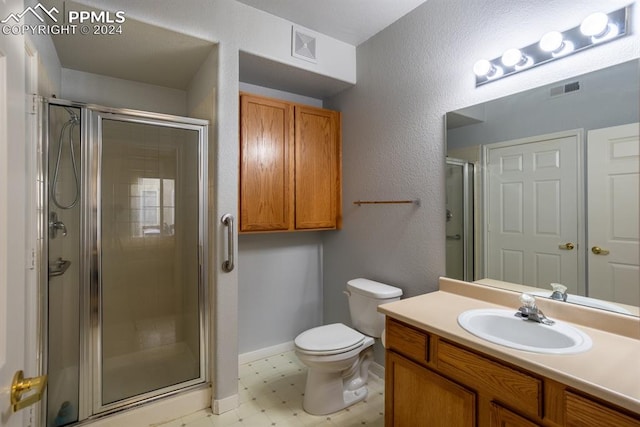 bathroom with an enclosed shower, vanity, and toilet