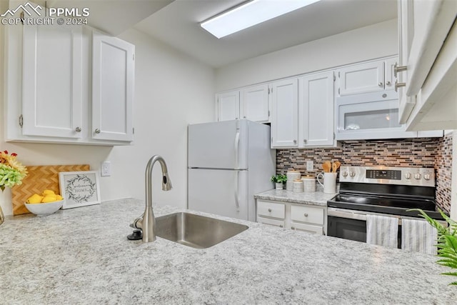 kitchen with decorative backsplash, white appliances, white cabinetry, and sink