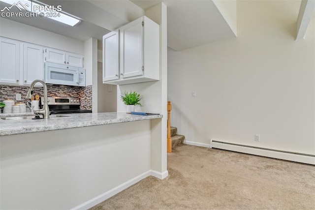 kitchen with light stone countertops, backsplash, light colored carpet, sink, and white cabinetry