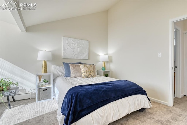 bedroom with light colored carpet and vaulted ceiling