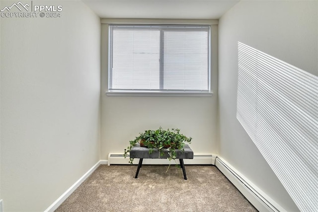 sitting room featuring light carpet and a baseboard radiator