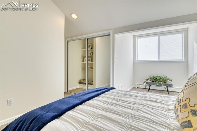 bedroom featuring a closet and a baseboard heating unit