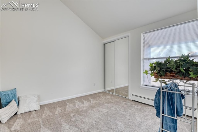 bedroom featuring carpet floors, baseboard heating, and lofted ceiling