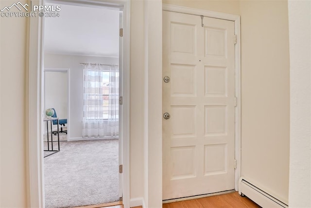 entryway featuring baseboard heating and light hardwood / wood-style flooring