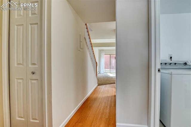 hall featuring washer / dryer and light wood-type flooring