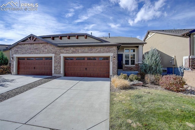 view of front facade with a garage and a front yard