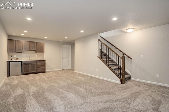 interior space featuring dark brown cabinetry, sink, light carpet, and stainless steel appliances