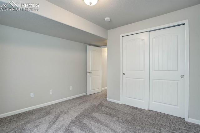 unfurnished bedroom featuring a closet and carpet floors