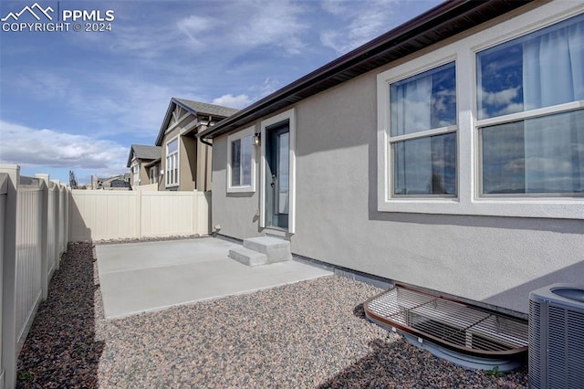 exterior space with a patio area and cooling unit