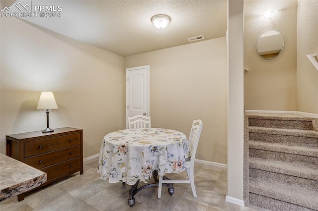 dining area featuring a textured ceiling