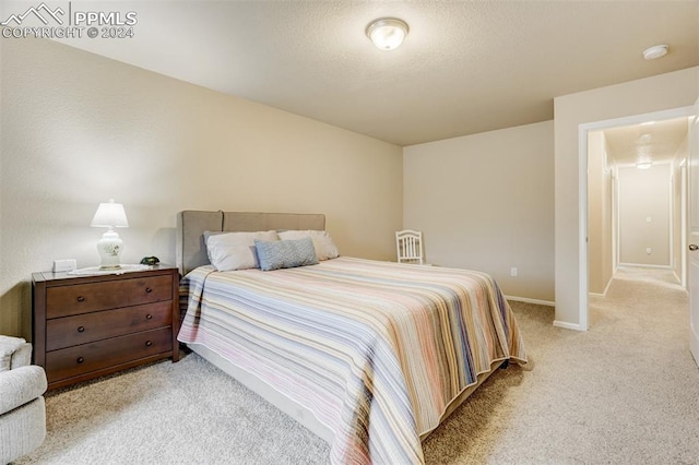 bedroom featuring light carpet