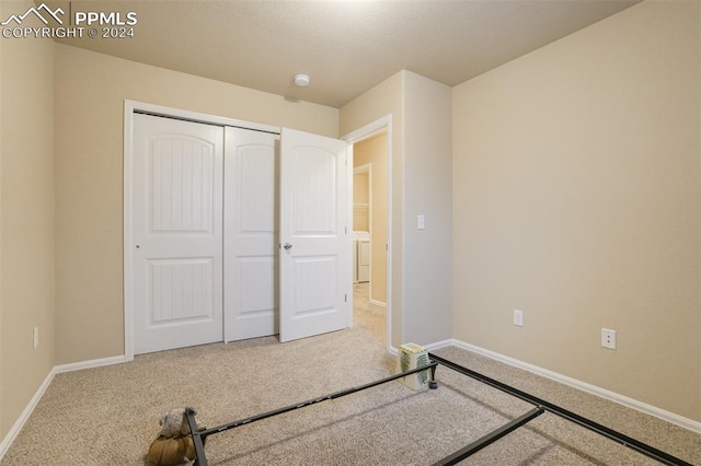 unfurnished bedroom featuring a closet and carpet floors