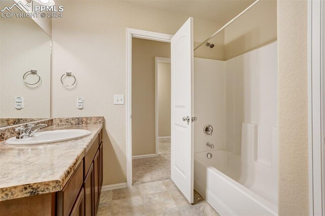 bathroom featuring shower / washtub combination, tile patterned flooring, and vanity