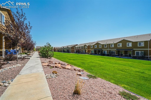 view of property's community with a lawn