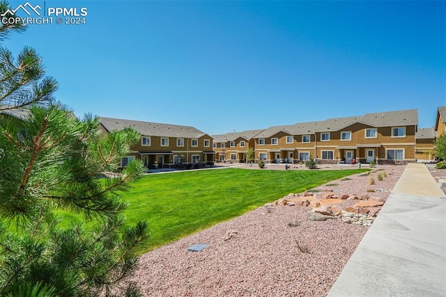 view of home's community with a yard and a patio area