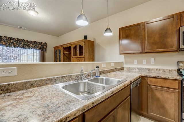 kitchen featuring hanging light fixtures, stainless steel dishwasher, and sink