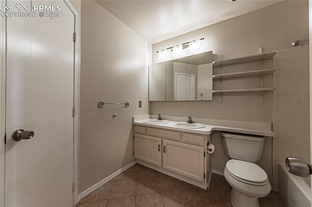 bathroom with tile patterned floors, vanity, and toilet