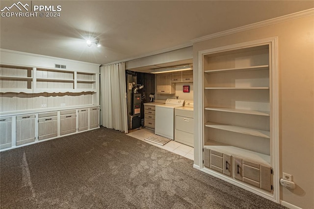 kitchen featuring washer and dryer, light colored carpet, heating unit, and ornamental molding