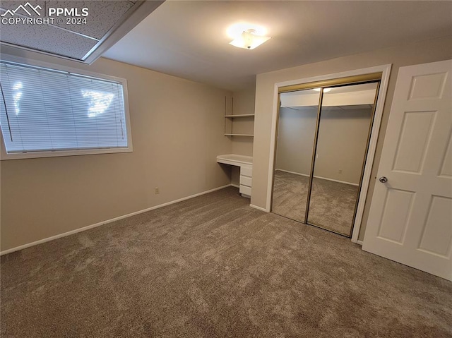 unfurnished bedroom with carpet and a closet