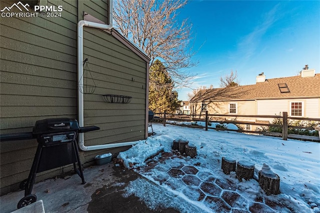 snow covered patio featuring area for grilling