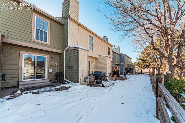 view of snow covered house