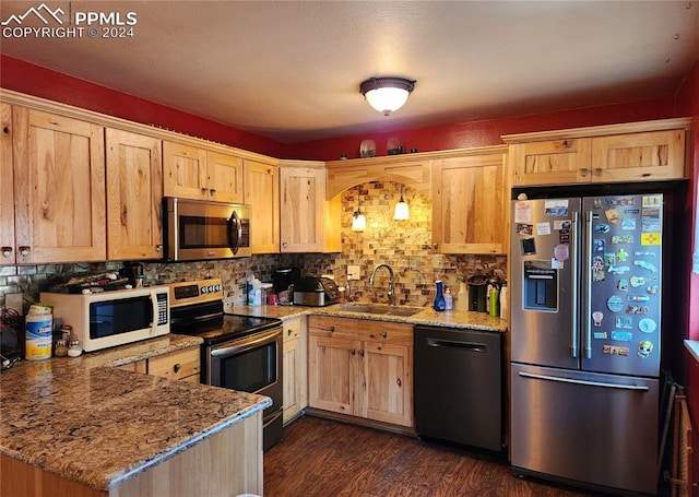 kitchen with light stone countertops, sink, dark wood-type flooring, stainless steel appliances, and light brown cabinetry