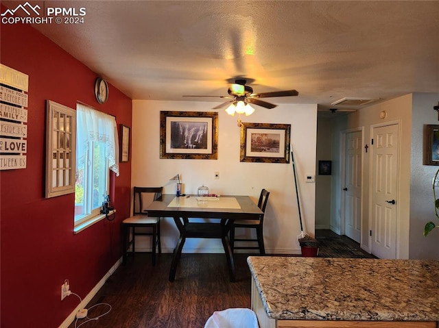 dining space with a textured ceiling, ceiling fan, and dark hardwood / wood-style floors