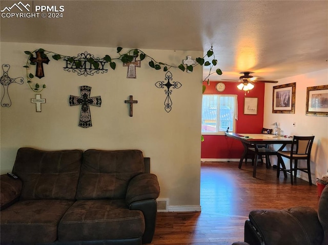 living room featuring dark hardwood / wood-style floors and ceiling fan