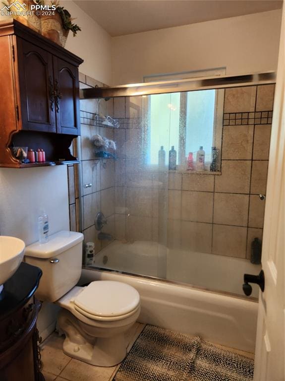 full bathroom featuring tile patterned floors, toilet, vanity, and combined bath / shower with glass door