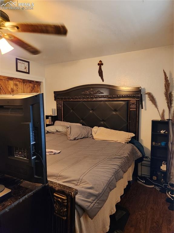 bedroom featuring ceiling fan and wood-type flooring