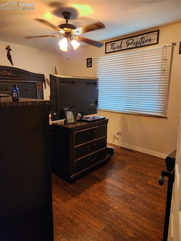 bedroom featuring ceiling fan and dark hardwood / wood-style floors